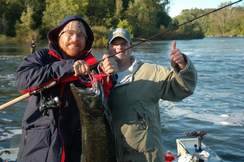 Writer Dave Mull holds a 17-pound St. Joseph River king hooked on a Luhr Jensen Coho Bolo with guide Scott Crouch. Photo by Kathy Terpstra