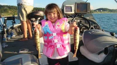 Samantha Rudlaff displays a pair of dandy Lake Michigan perch caught fishing with her father Elmer.
