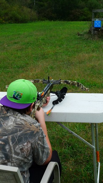New crossbow hunter Jesse Boven of Paw Paw, Michigan, first takes shot resting his Excalibur on a bench, getting used to pulling the trigger. Then he practices freehand shots. Next step should be target shooting from a tree stand.