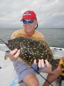 Louisiana Sportsman magazine owner Tony Taylor and a thick flounder. Photo: Lew Carpenter