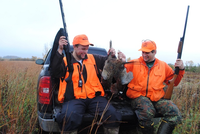 Isaiah Battel and Joe Lounsbury compare pheasants.