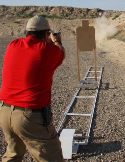 The cardboard target riding the trolley falls toward the shooter when it reaches the end of the travel.