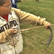 Under the guidance of expert traditional bowmen, young archers try their hand at shooting a bow.