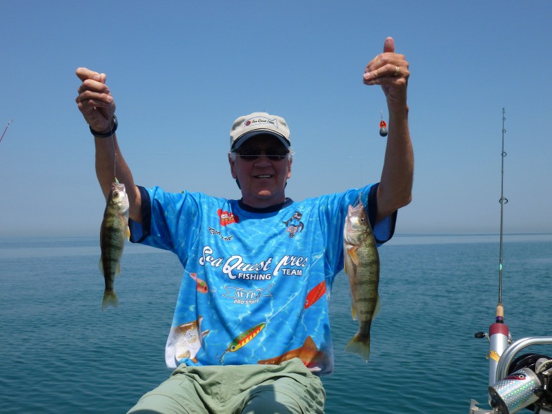 Richard Holm holds up two Lake Michigan perch.
