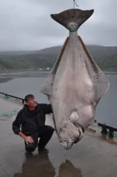 Liebenow poses next to his prize catch, which is a good deal taller than he is.
