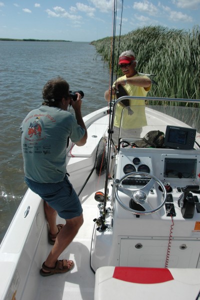 A background of trees, water, or other natural features can serve to make any fishing photo much more appealing.
