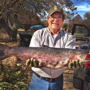 A joyous Mark Reed holds up his record rainbow trout.