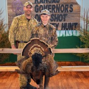 NWTF hunt winner Ian Shofner (right), and guide Joel Pile (left), pose with their turkey taken at the Kansas Governor's One Shot Turkey Hunt.