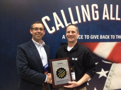 Outdoor Life's Andrew McKean presents Jordan Vermillion from Bushnell with Great Buy award.