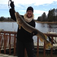Katie Pieper holds the trophy northern pike that she and Katie Berg took during the transitional time of ice-in and ice-out on Lake of the Woods.