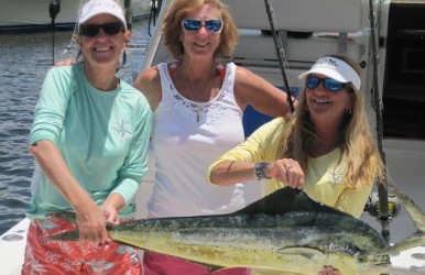 Women proudly hold their fish caught on Reel Busy.