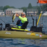 Rich Ofner poses with a nice largemouth caught while drifting on Lake St. Clair—moments later he dropped it back in the water to fight an bigger smallmouth that grabbed his dangling tube bait.