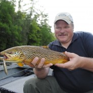 Denny Bouwens shows off a nice brown trout taken on a Rapala.