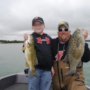 Wyatt and Chris Noffsinger show off their smallmouths from Chris' day-off fishing trip on the waters of the Grand Traverse Bay.