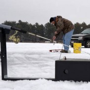Mark Stange resets a line while fishing for brown trout.