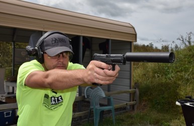 Matt Ohrstrom shoots an HK VP9 with a suppressor. Image by Matt Korovesis.