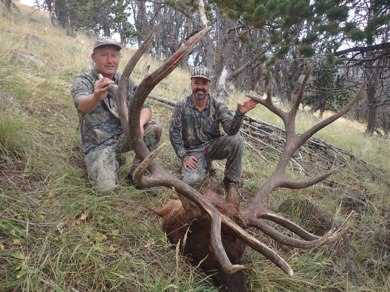 Albert Henderson (right) smiles over his world record bull elk alongside hunting buddy Larry Michaels (left).