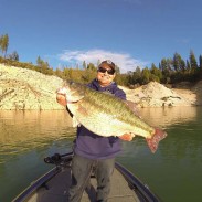 Tim Little holding up his massive spotted bass for the camera.